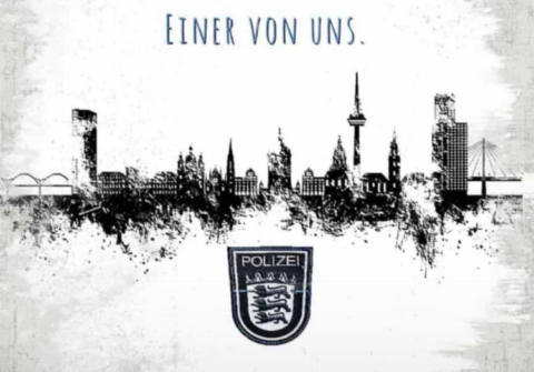Das Foto zeigt eine Zeichnung der Sykline von Mannheim, darunter das Wappen von Baden-Württemberg. Über der Skyline steht "Einer von uns." Das gesamte Bild gleicht einer Bleistiftzeichnung und ist in Schwarz-Weiß gehalten.